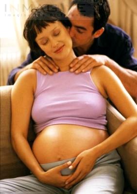 Partner massaging pregnant mum.